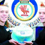 KITTED OUT: Adam and Nick Crabtree with a cake made as a special treat by chef instructors