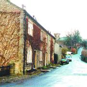 PAST AND PRESENT: The beautiful village of Downham, in the shadow of Pendle Hill, has changed surprisingly little over the years