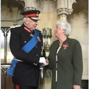 June Steele receiving her medal from Lord Shuttleworth