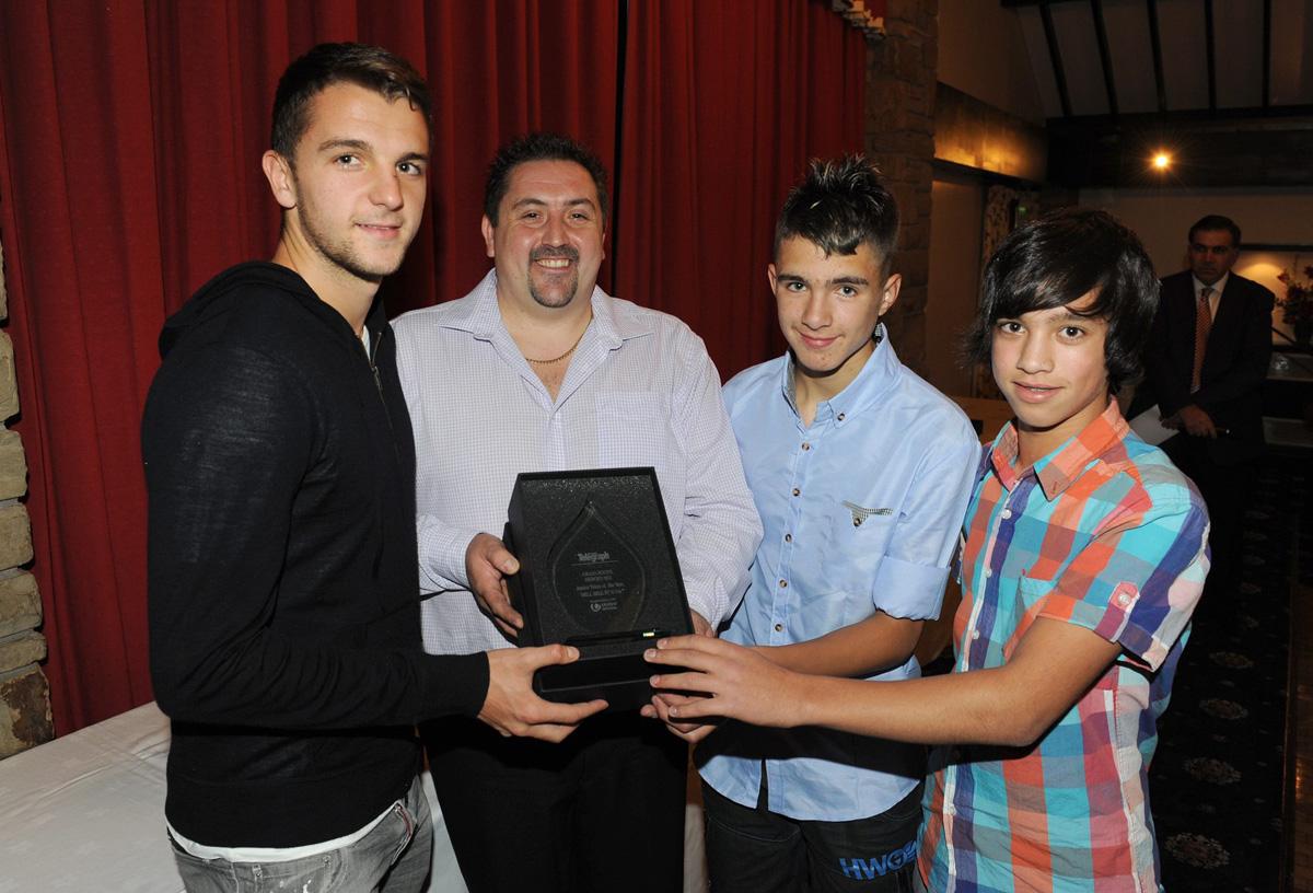 Jay Rodriguez of Burnley FC presents Jason Close, Reece Thompson and Harvey Close of Mill Hill Under 13's with the Junior Team Award, during the Grassroots Awards 2011.