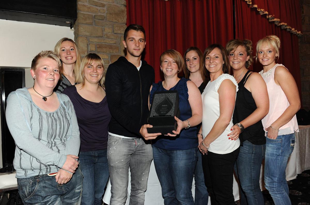 Jay Rodriguez of Burnley FC presents Captain Debbie Slater of the Witton Warriors Ladies Hockey Team with the Senior Team of the Year Award, during the Grassroots Awards 2011.