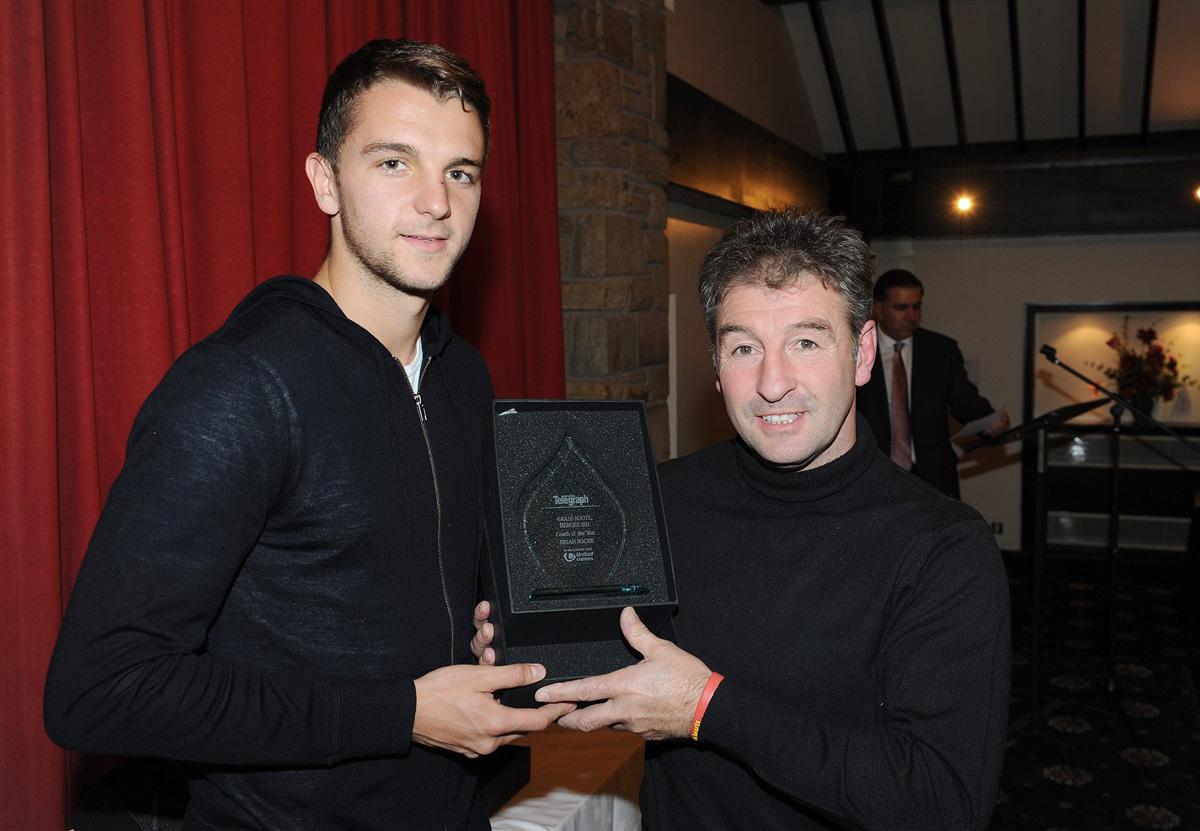 Jay Rodriguez of Burnley FC presents Brian Roche with the Coach of the Year Award, during the Grassroots Awards 2011.
