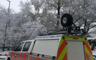 Mountain Rescue team helps ambulance, blocked by snow, reach patient