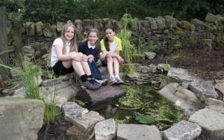 From left, Ruby Brooks, Sami Ladds and Amy Garroch in the pond area at school