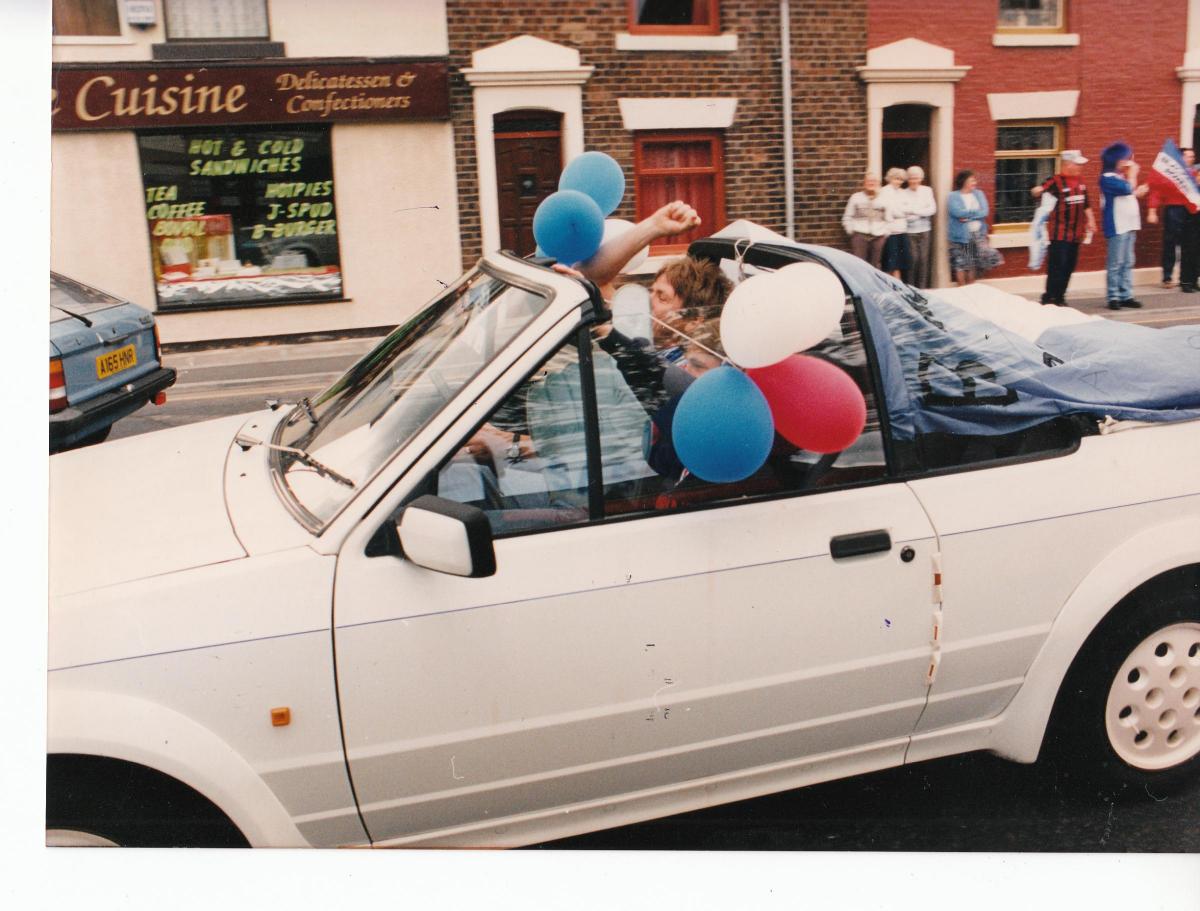 A balloon festooned car passes Ewood Park in 1995.