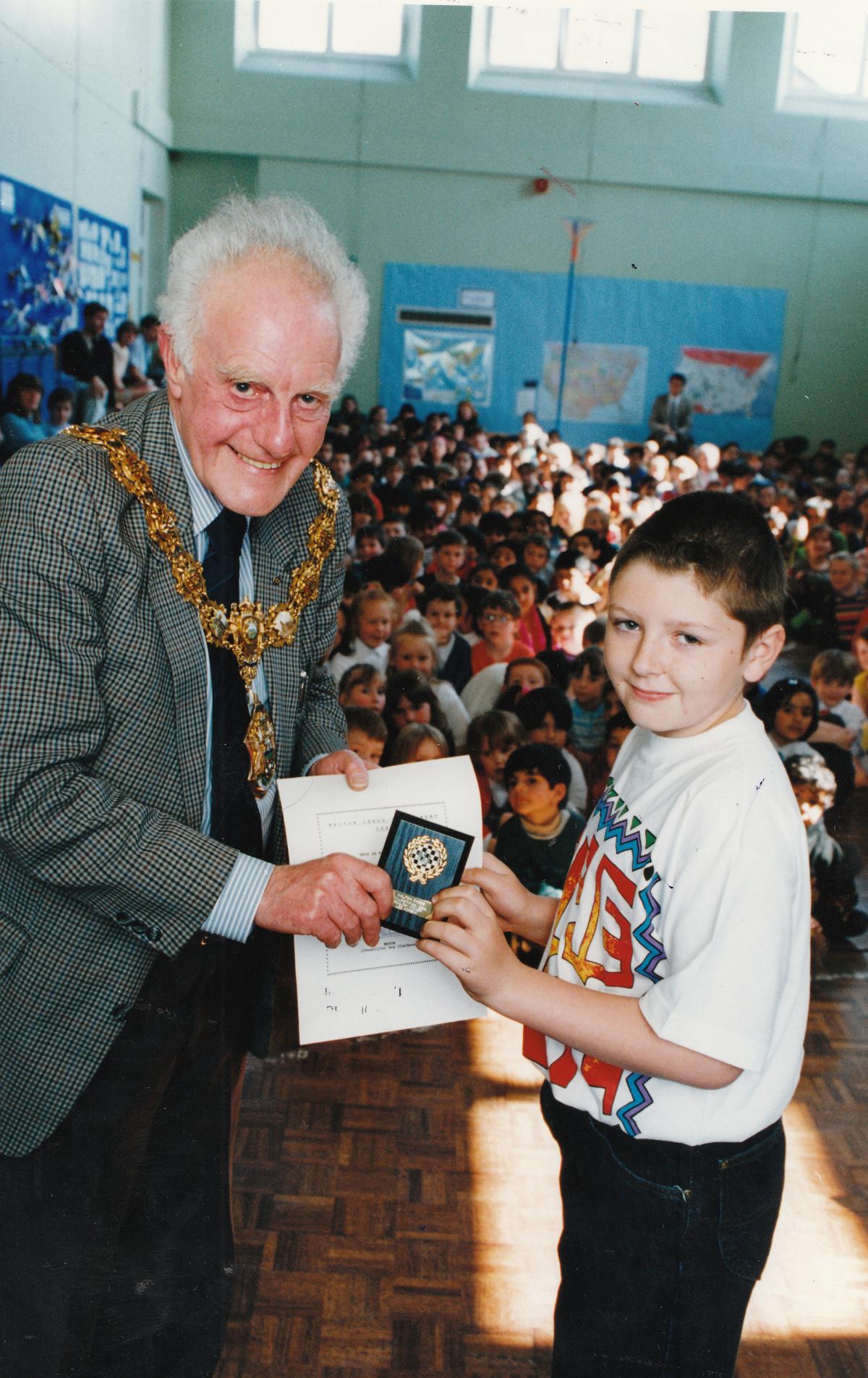 Mayor of Pendle Roy Clarkson presents a plaque to Lee Hopson as winner of Walton Chess competition