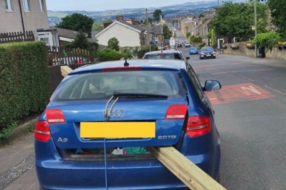 Driver caught with huge wood planks sticking out of car