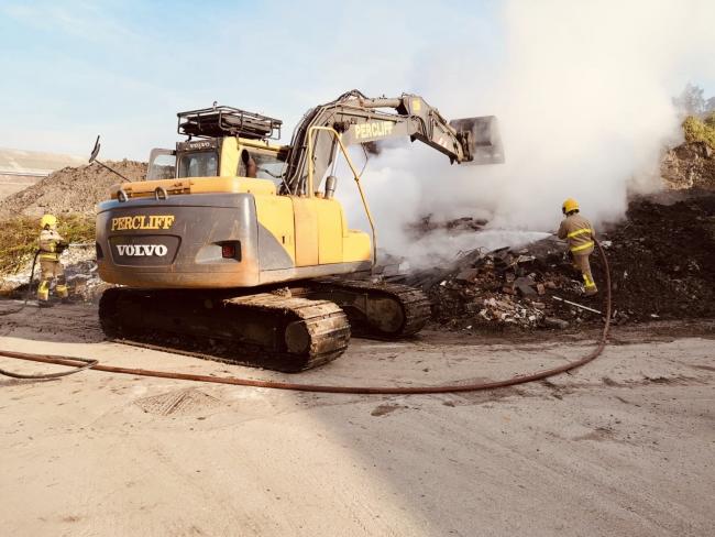 Crews tackled a fire on Percliff Way in Blackburn and used a JCB to assist in shifting the rubbish and soil