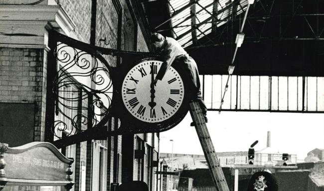ALL CHANGE: Adjusting one of the clocks at Blackburn station