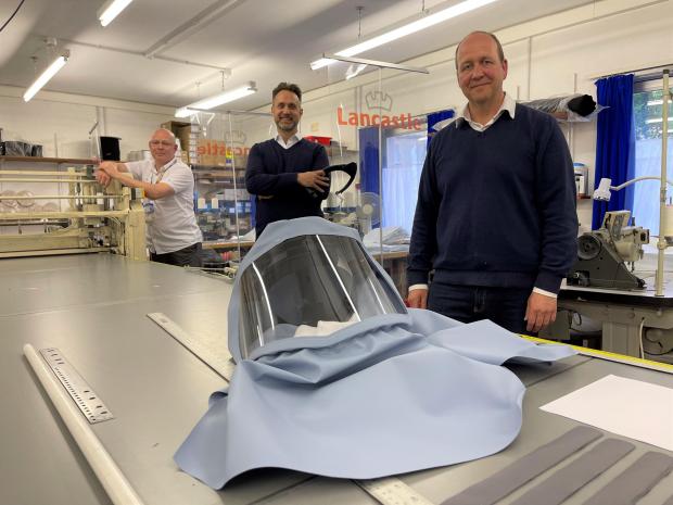 Lancashire Telegraph: (left to right) Stuart Hosking Durn, Michael Fraser and Neville Clokey with a new full-face protective hood. The defence and aerospace company teamed up with Lancashire-based family-owned firm Lancastle to come up with what has become known as the Morecambe Bay Hood.