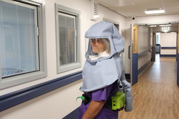 Lancashire Telegraph: Matron Sally Young wearing a new full-face protective hood. The defence and aerospace company teamed up with Lancashire-based family-owned firm Lancastle to come up with what has become known as the Morecambe Bay Hood.