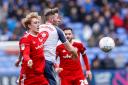 Stanley's Harvey Rodgers battles Bolton's Daryl Murphy in the air