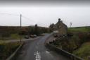 Road closed after car crashes into dry stone wall and flips onto roof