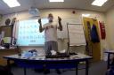 Bruce in the class showing some of the items he and his group have found while they have been out exploring
