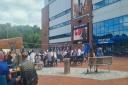Fans at Ewood Park watching the game on a screen.