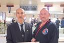 Grandmaster Cho and Master Charles Boyle receiving his 7th degree certificate.