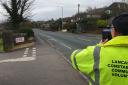 A Community Roadwatch Volunteer checking the speed of motorists