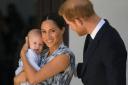 The Duke and Duchess of Sussex hold their son Archie during a meeting with Archbishop Desmond Tutu in South Africa (PA)