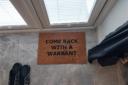 A welcome mat inside one of the raided properties