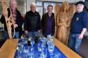 Pictured is some of the glassware on display with  co-ordinator Bryan Jones (2nd from left), and members of Builth Wells Rotary Club who helped with staging the exhibition. Two wooden carvings, including the 6 feet tall figure are also shown on the