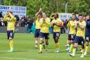 Oxford United players applaud the away support at Exeter City