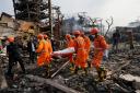 National Disaster Response Force rescuers carry the body of a person after an explosion and fire at a chemical factory in Dombivali near Mumbai, India (Rajanish Kakade/AP)