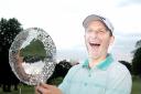 TRIUMPH: Michael Hunt celebrates with the Harold Ryden Trophy after a victory over Blackburn’s Anthony Harwood on his home course of Pleasington on Wednesday night