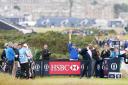 ILLUSTRIOUS COMPANY: Clitheroe’s Mark Young (left) watches Justin Rose tee off at St Andrews yesterday