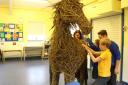 Students at St John's Church of England Primary School working to create a life sized war horse and large willow poppies