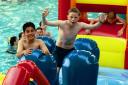 Young swimmers enjoy the inflatable Fun Night at Blackburn Waves