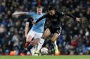 Burnley's Dwight McNeil under pressure from Manchester City's Kevin De Bruyne