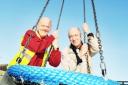 PLAY PALS: Playground officer John Edmondson and resident Michael Mobey with the new swing in place at Burnley Wood