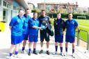Nigel Dixon hands over a friendship plaque to a Barcelona junior coach