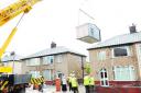 HOME IMPROVEMENTS: A crane carefully lowers the extension to the Panwaskars’ home on Churchill Road, Little Harwood