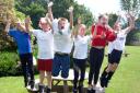 Coates Lane Primary School pupils jumping off of a bench, showing their support for England
