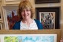 Artist Gillian Ousby with one of her paintings