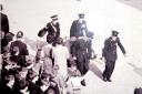 A fainting victim is taken away by stretcher in October 1965