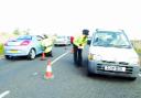 ROAD BLOCK:  Police stop motorists on Burnley Road East, near where Paul Brady, above, was attacked by an armed gang and bundled into a vehicle