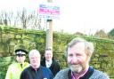 deterrent: John Schofield with PC Pickles, Parish Council chairman Jeff Haydock and trading standards’ Ed Culshaw below one of the signs