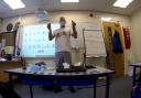 Bruce in the class showing some of the items he and his group have found while they have been out exploring