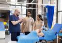 A tutor teaching some students at the Burnley-based medical institute