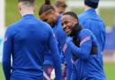 Raheem Sterling enjoys a laugh on the England training ground