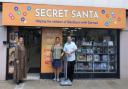Mall general manager Loraine Jones (left) with Secret Santa founders Phil and Karen Boulding