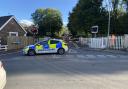 Road closed in both directions after car hits level-crossing barrier