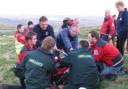 TREATMENT: Paramedics and Bolton Mountain rescuers attend to the injured cyclist
