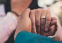 A woman wearing an engagement ring. Credit: Canva