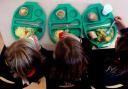 Photo via PA shows children eating school meals.