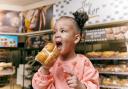 A child eating Morrisons hot cross bun