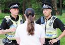 SWOOP: Police officers PC Nigel Keates and PC Ivan Brown quiz a prostitute in Bank Hall park, Burnley