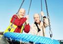 PLAY PALS: Playground officer John Edmondson and resident Michael Mobey with the new swing in place at Burnley Wood